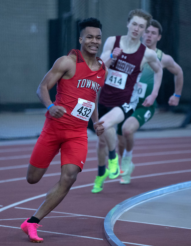 East Providence High School's Kit Ruddock rounds a turn en route to winning the boys' 300 meter title at the 2023 state indoor track and field meet Saturday, Feb. 18.