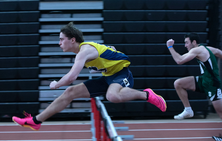 Barrington&rsquo;s Ethan Knight sprints over a hurdle during the 55-meter hurdles event at the state track championship.