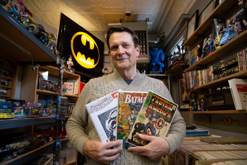Dave Hennan of East Bay Comics holds a small selection of the tens of thousands of comic books on offer in his Hope Street shop. The Spider-Man on the left features original, one of a kind artwork; on the right is the first Captain America comic book. The Batman in the middle is more accessibly priced for the fan or casual collector.