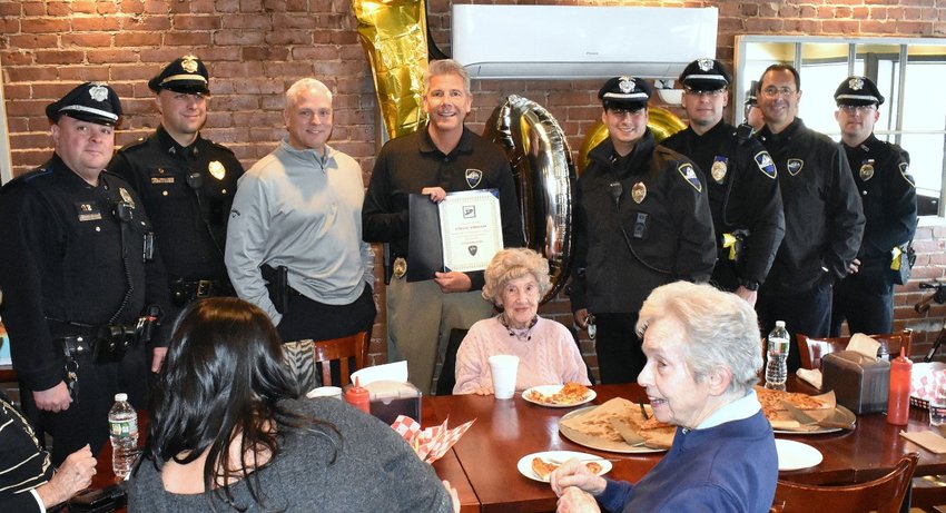 Members of the Bristol Police Department, headed by Chief Kevin Lynch (center) present Genevieve Marszalek a commemorate citation in recognition of her 109th birthday.