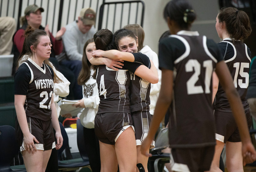 Korynne Holden gives senior Leah Sylvain a hug after losing to Sutton 46-35 in the Division 5 Elite 8 on Friday.