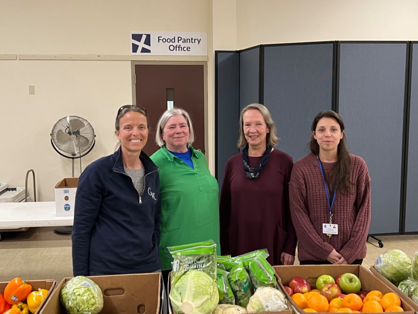 Dee Proulx and Wendy Baker of the St. Mary of the Bay Food Pantry, alongside Kim Wetherald, Director of Volunteer Services at EBCAP, and Nicole Giroux, coordinator of the mobile food pantry program for EBCAP, after discussing the program at the food pantry in Warren on Monday.