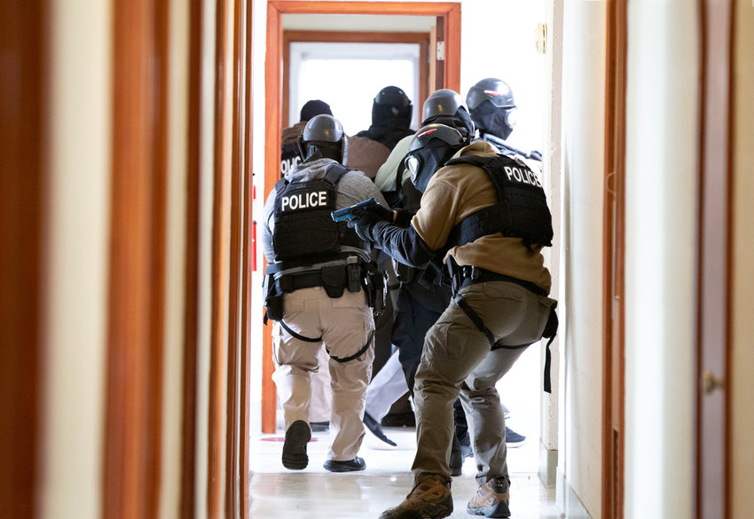 Providence Police Lt. Robert Papa covers the rear as a group of policemen look for an active shooter during a drill held inside the former Carmelite monastery.
