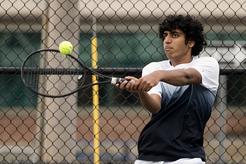 Vineet Abbineni hits the ball back toward his Moses Brown opponent during Thursday's home match.