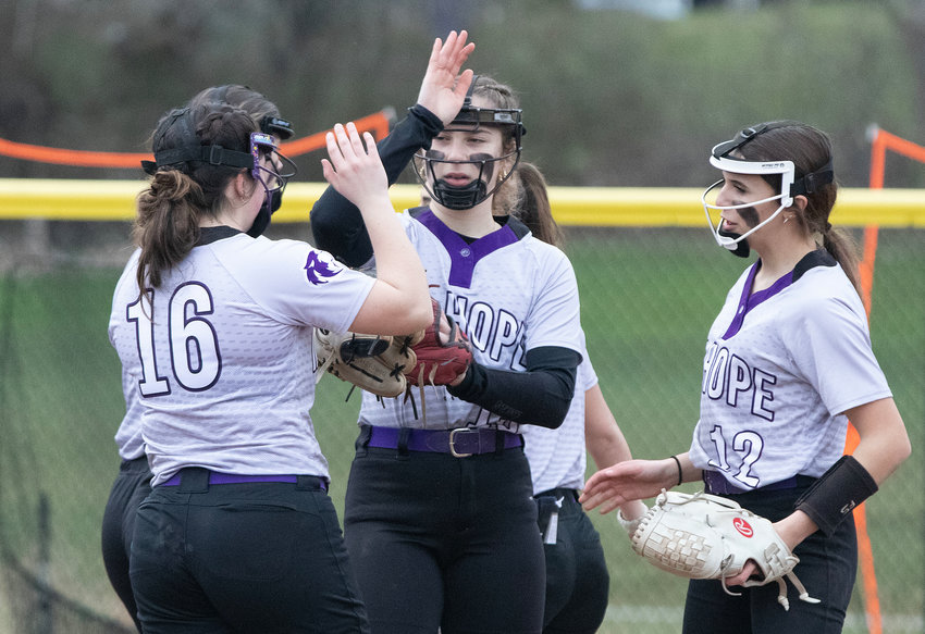 Sammy Malafronte (left) high fives pitcher Reily Amaral (middle) after a clean inning during their game against Lincoln on Thursday. Mt. Hope won 9-1.