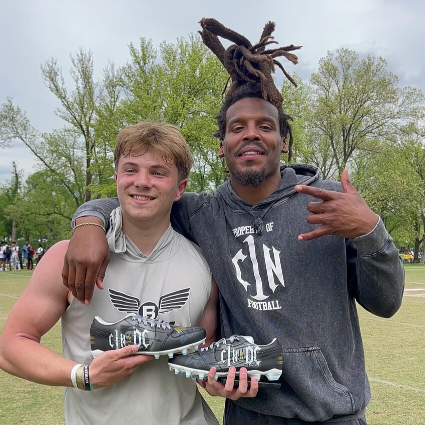 Barrington's Alex McClelland (left) receives a custom-painted pair of cleats from former NFL MVP Cam Newton after leading his team, Breakthrough Elite, to a 6-0 record in the Cam Newton 7-on-7 football tournament last weekend. McClelland, who plays quarterback, was named MVP of the tournament.