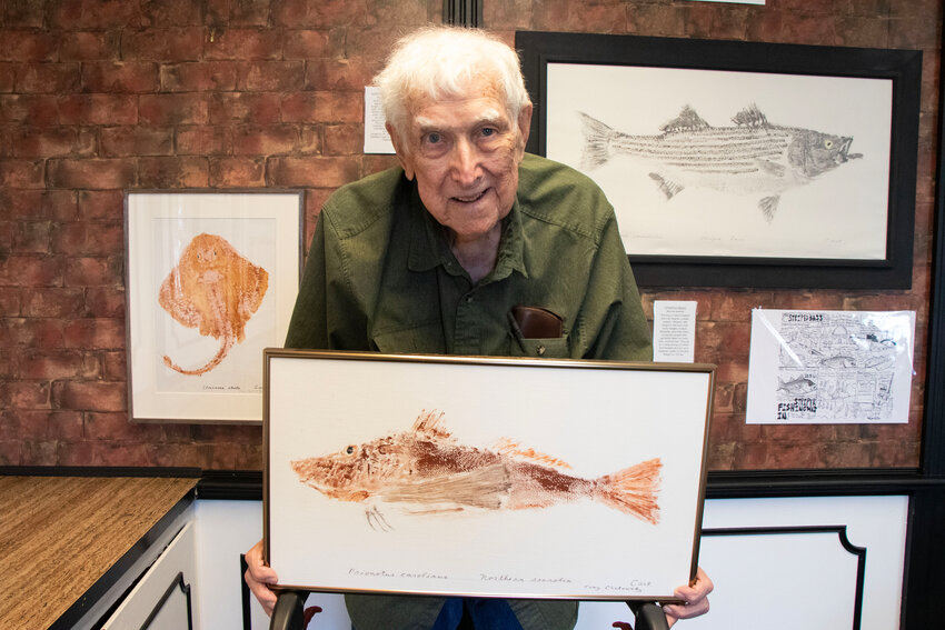 Tony Chatowsky with one of the Gyotak-method prints on display at his new Fish Print Museum on East Main Road. This is a print of a northern sea robin which, like all the others on display, he caught himself.