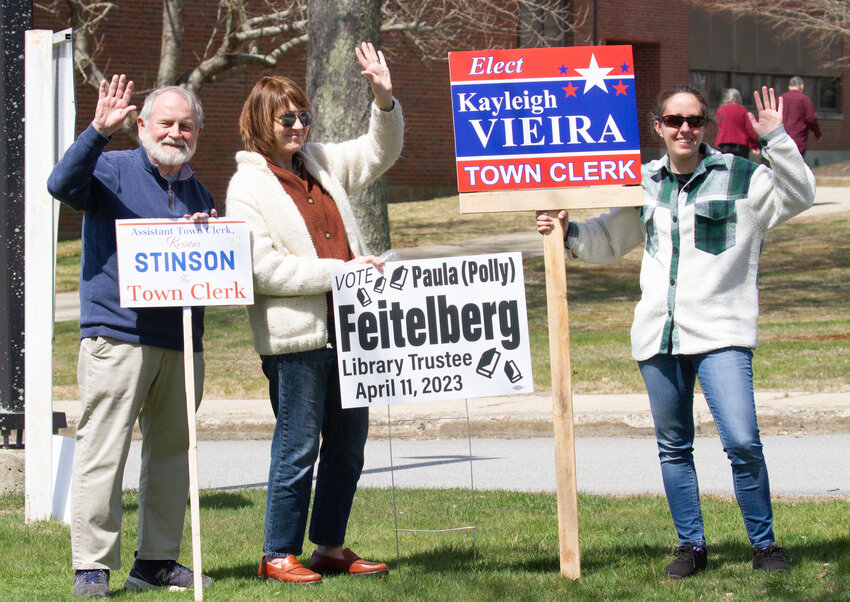 Candidates and supporters wave on arrivals at voting last Tuesday in Westport.