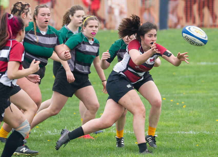 University of Massachusetts fly half Bella Pomeroy tosses the ball to a teammate during a game against the University of Vermont (UMV), which romped to a 66-0 victory on Saturday &mdash; the highest-scoring game in the bracket.