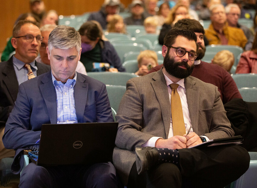 Sakonnet Partners engineer Joseph Malo (left) and funeral director Jonathan Ferreira, listen as residents speak out against the crematorium at a meeting earlier this year.