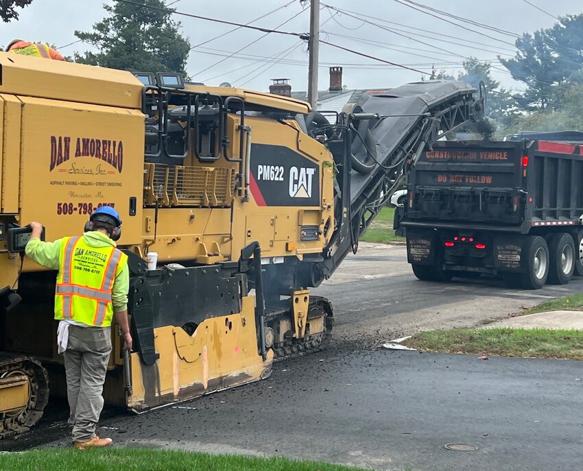 Crews mill a road in city in the fall of 2022 in preparation of dropping a new layer of asphalt.