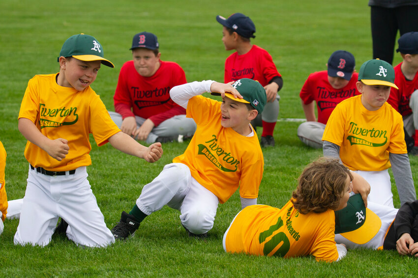 Members of the Tiverton Little League A's stretch before their first game of the season Saturday.
