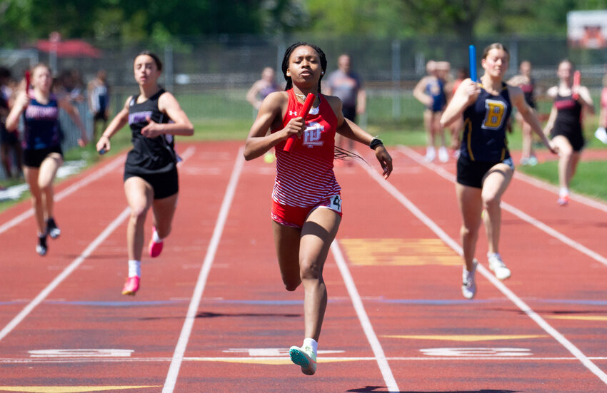 Anchor runner Nazarae Phillip crosses the finish line first as the EPHS girls' 4x100 meter relay team won the event at the 2023 Eastern Division Championship Meet Saturday, May 6, in Barrington.