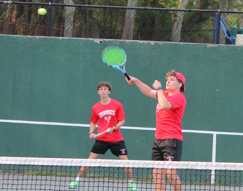 Jaydon Amaral hits an overhead at net while his partner on the EPHS boys' No. 2 doubles team Nathan Thurber looks on during their match against PCD Monday, May 8.