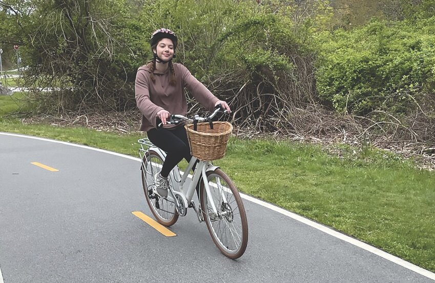 Author Julia Stearly pedals a Class 1 electric bicycle on the East Bay Bike Path while traveling south from Colt State Park.