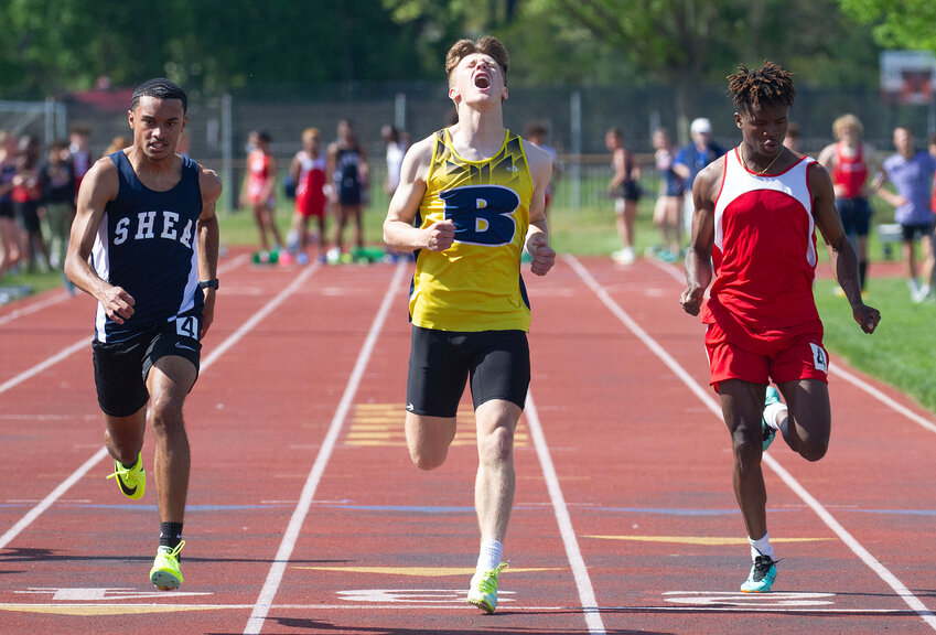 Barrington's Iain DeBoth (middle) powers across the finish line in the 100-meter race.