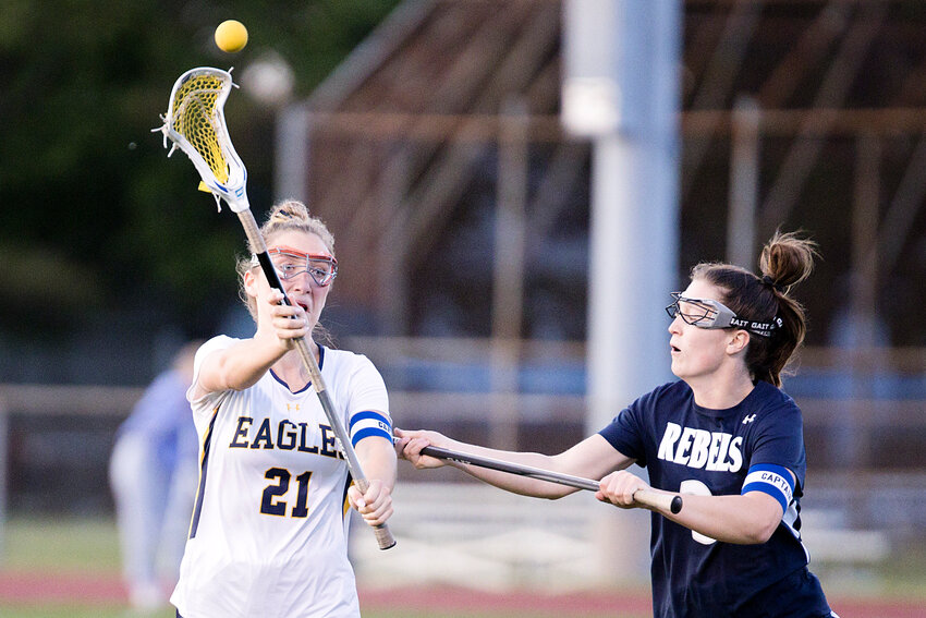 Violet Gagliano sends a pass to a teammate while pressured closely by a South Kingstown defender.