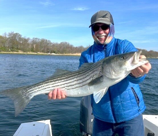 Jim Lundy with a spring striped bass caught in the East Passage of Narragansett Bay off Prudence Island.