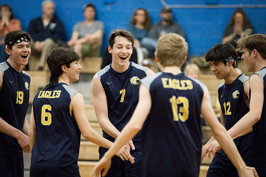 James Ciummo (middle) is congratulated by teammates after serving consecutive aces in the first set against Toll Gate, Tuesday.