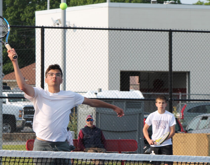 Tiverton's Adam Costa hits an overhead as partner Aidan Sweeney watches on during their win at third singles for the Tigers over East Providence in the D-II playoffs Tuesday, May 23.