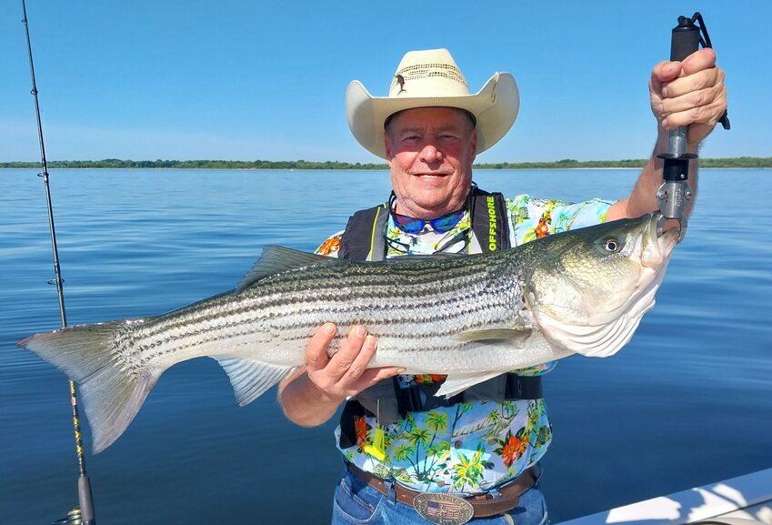 Tim Rounds, of Idaho, here on vacation, caught this 38&rdquo; striped bass (his first ever) fishing with light tackle at Popasquash Point, Bristol on No Fluke Fishing Charters.