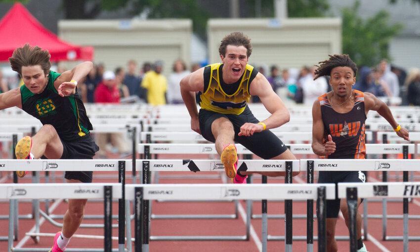 Barrington's Ethan Knight (center) clears a hurdle in the 110-meter hurdles event at the state track championship. Knight finished fifth at the New England Track and Field Championships.