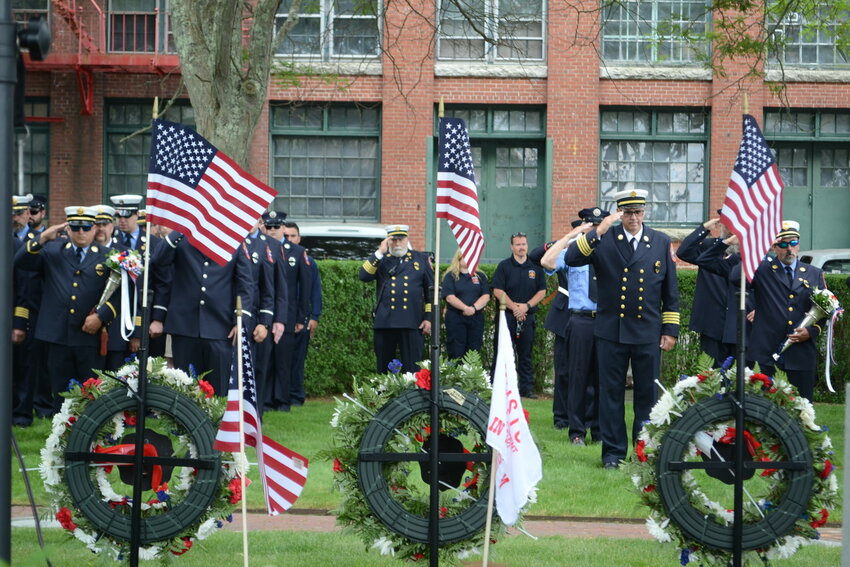 Firefighters salute wreaths during the memorial commemoration event last year.