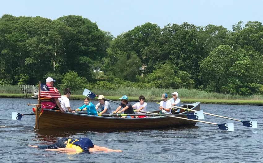 Youth rowers train on responding to a man overboard situation.