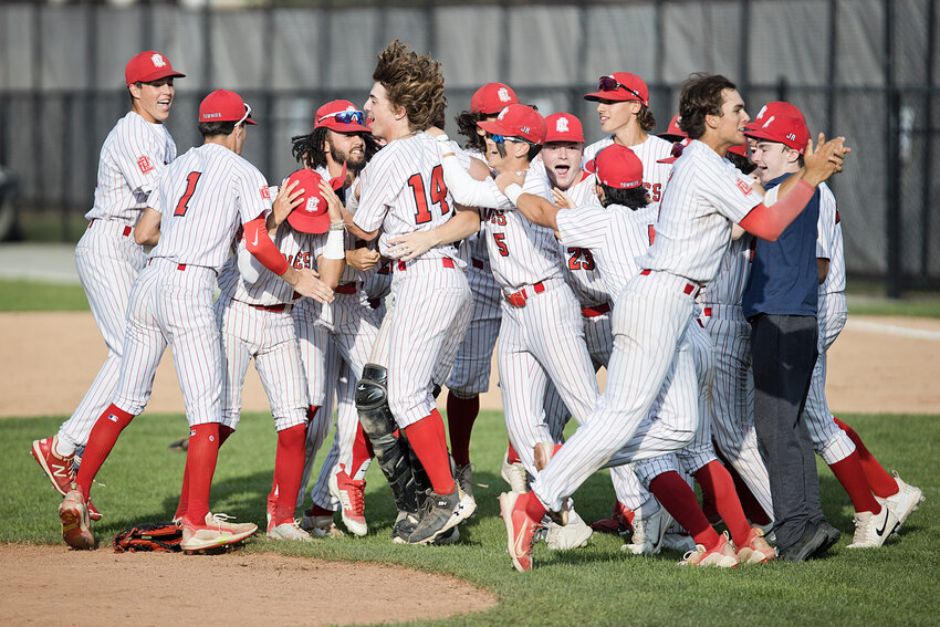 The EPHS baseball team charges pitcher Tim Robitaille after the final out of the Townies' 1-0 win over East Greenwich for the 2023 Division II championship Monday, June 19.