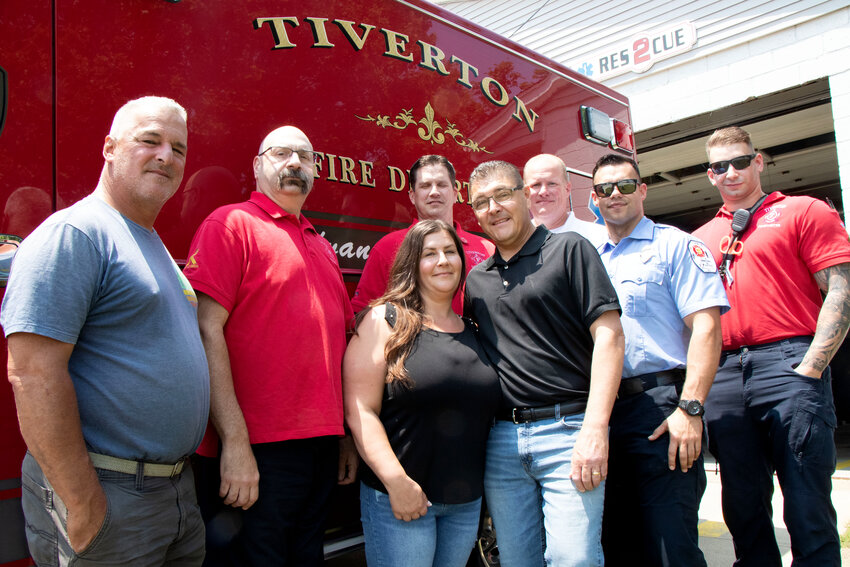 Steve Oliveira and wife Dawn (middle) pose with Tiverton first responders Jim Miranda (left), Lt William Pannicia, Lt Mike Ladusau, Nicholas Barboza, Captain Peter Manchester and Brandon Botelho, who all aided in saving his life.&nbsp;&nbsp;