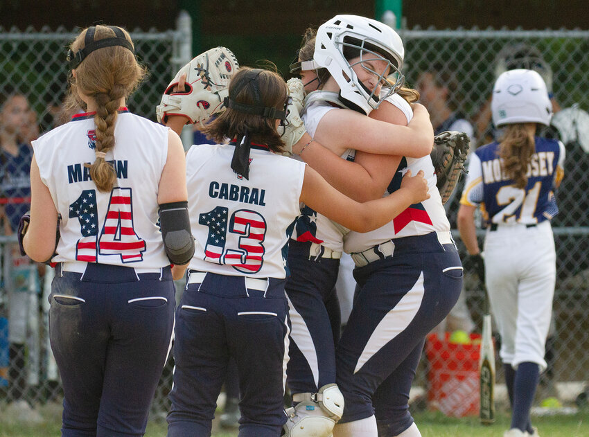 Teammates lineup to celebrate with pitcher Liliana Luis after she threw a perfect game. The Tiverton 12U all stars beat Barrington 2-0 at Town Farm Field on Thursday and move on to the finals on Tuesday night.