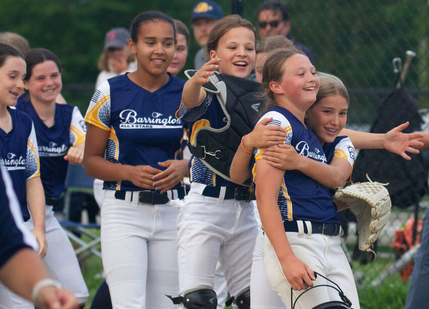 Barrington teammates swarm Ava Lucas (right) after the game. The pitcher threw a no hitter and struck out 10, allowing just 3 walks and no runs. She also hit a triple and scored in the second inning.
