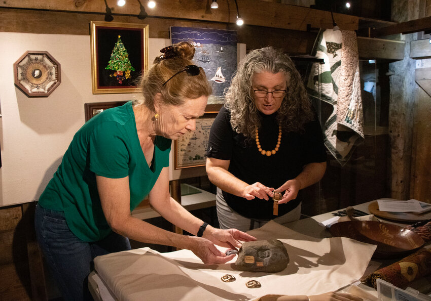 Dora Millikin (left) and director Marjory O'Toole work on the exhibit one recent afternoon.
