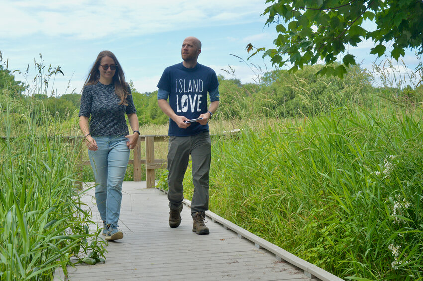 Leah Kossak, marketing and engagement director the Aquidneck Land Trust, strolls through part of Little Creek Preserve with Alex Chuman, the Trust&rsquo;s conservation director.