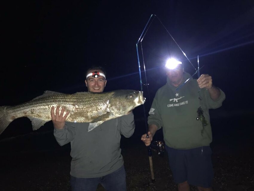 Barrington&rsquo;s Brendan Watson (left) proudly displays the 40-pound striped bass he caught late last month. His father (right) holds up the broken fishing rod.