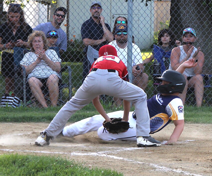 Barrington's Leo Espindle slides safely into home under the tag of Rumford's Wyatt Vanech during the 10u All Star game between the sides Saturday, July 8.