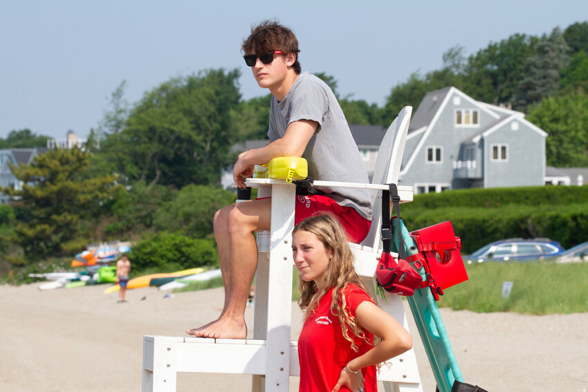 Lifeguards Parker Hughes (seated) and Violet Gagliano check the water at Barrington Beach earlier this summer.