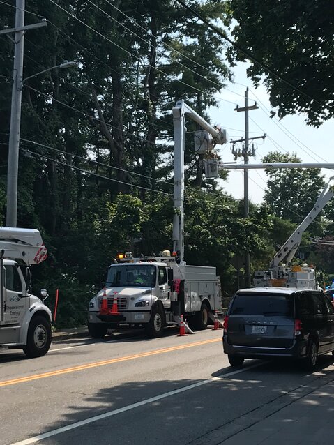 Rhode Island Energy crews work to repair lines after a pole fire in Barrington on Wednesday afternoon.