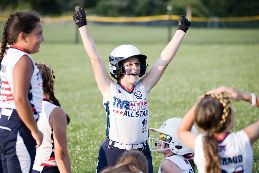 Autumn Mottram celebrates with her team after beating Barrington 11-1 in the district finals, Wednesday.&nbsp;