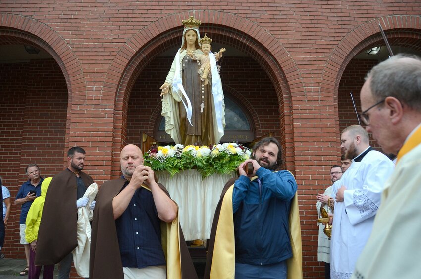 The statute of Our Lady of Mt. Carmel is carried outside the church to start the 125th annual feast procession.