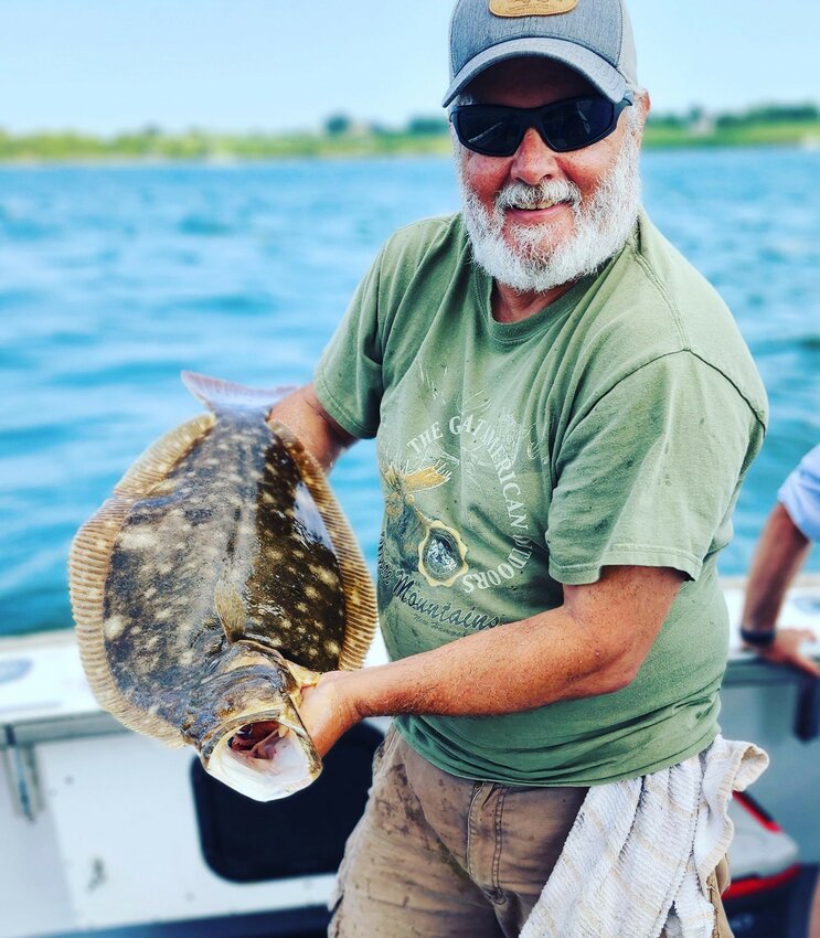 Paul Philips of North Kingstown with the nine-pound summer flounder he caught in deep water off Newport last week on ArchAngel Charters.