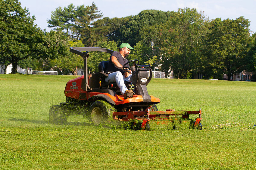 A Barrington DPW worker cuts the grass at Chianese Field last week. Traverse Landscape Architects is taking an in-depth look at athletic fields in Barrington.