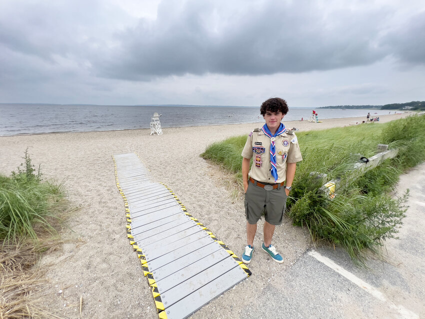 Barrington resident Quincy Burke stands beside the accessible path he built at Barrington Beach as part of his Eagle Scout Project.