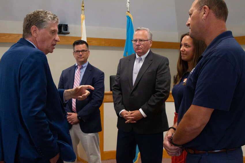 At Town Hall last week, Gov. Daniel McKee discusses the Learn365RI Municipal Compact with (from left) Superintendent Thomas Kenworthy, Town Administrator Richard Rainer, Jr., and Holly Buresh and Capt. Jonathan Kabak of Oliver Hazard Perry.