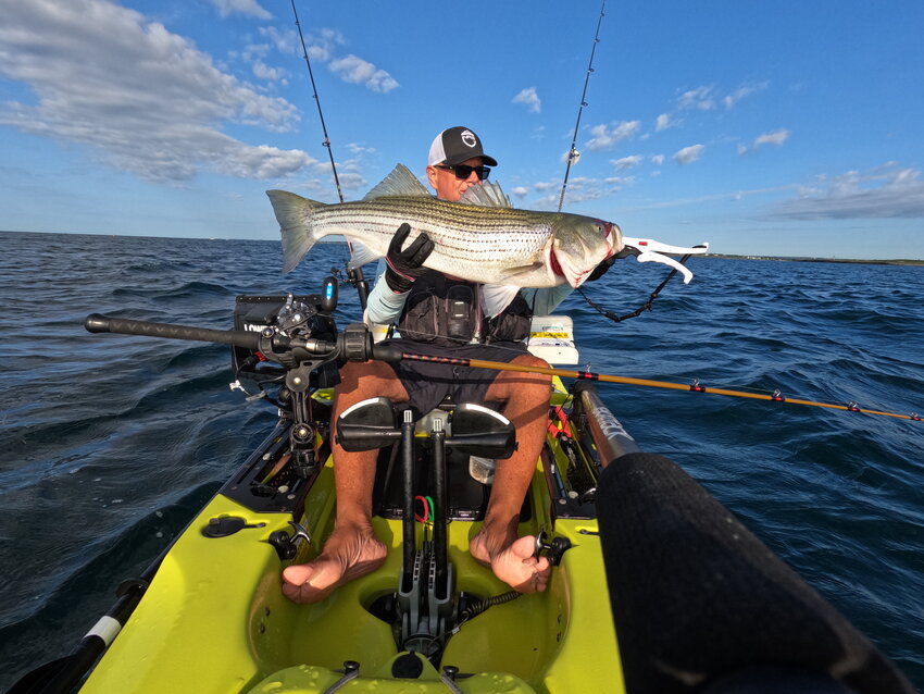 Tom Houde of West Warwick with the 39&rdquo; striped bass he caught trolling tube and worm with his kayak off Newport at Brenton Reef.