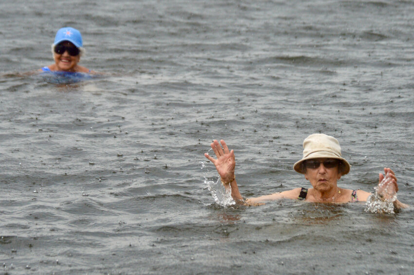 Portsmouth residents Beth Shumway (left) and Virginia Lowney wade in the waters of the Sakonnet River as light rain starts coming down last Thursday afternoon, Aug. 10. &ldquo;It makes you feel rejuvenated,&rdquo; said Shumway, 89.