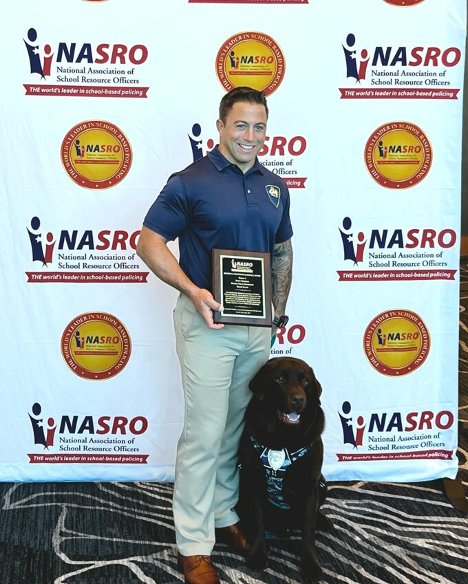 SRO Keith Medeiros and K9 Officer Brody, shortly after Medeiros was given the the Floyd Ledbetter National School Resource Officer of the Year Award at the National Association of School Resource Officers annual summit in Indianapolis, Indiana.