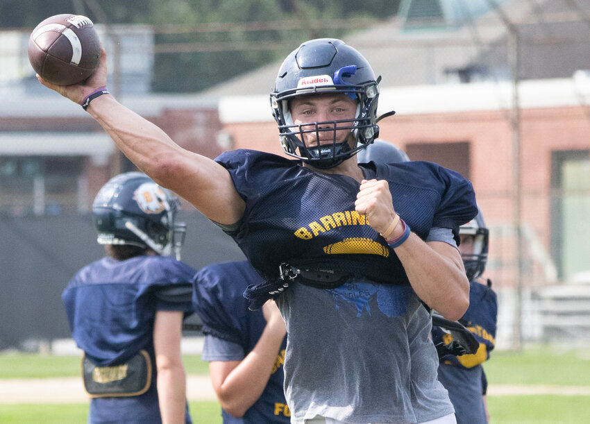 Barrington High School quarterback Alex McClelland throws a pass during preseason practice on Monday morning, Aug. 21.
