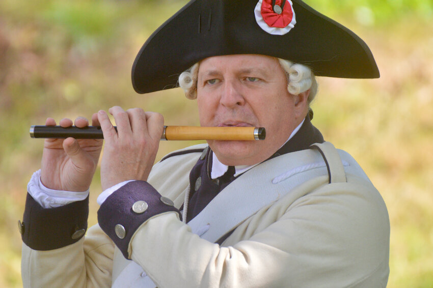 Bill Phoenix, of the Middlesex County Volunteers Fifes &amp; Drums, plays The National Anthem with other members of the group at the start of Saturday&rsquo;s celebration hosted by the Battle of Rhode Island Association at the Butts Hill Fort property. The event marked the 100th anniversary of Dr. Roderick Terry purchasing the property and saving it from development.