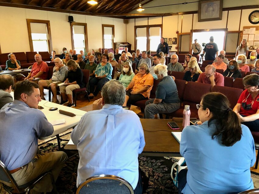Prudence Island residents fill Union Church during the Town Council&rsquo;s September 2021 on the island. In the foreground are (from left) council member Keith Hamilton, Town Administrator Richard Rainer, Jr., and Town Clerk Jennifer West. The council has tentatively scheduled another meeting on the island on Saturday, Sept. 23, although it won&rsquo;t be at the church.